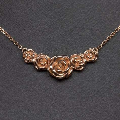 This beautiful and unique botanical necklace features a cluster of blossoming roses intricately rendered in 14k rose gold. Inspired by the boundless and surprising beauty of the natural world, this necklace offers a dreamy air of fairytale romance! The necklace is pictured in solid 14k rose gold and can be made in yellow or white gold as well. The pendant measures 21.6 x 8.8mm. The chain is 18 inches in length. This unique botanical necklace is an Ivy and Rose original design, so you will not fi Pendant Necklace Outfit, Rose Necklace Gold, Gold Rose Flower, Botanical Necklace, Fairytale Romance, Rose Gold Pendant Necklace, Rose Blossom, Shiny Rings, Pendant Necklace Simple