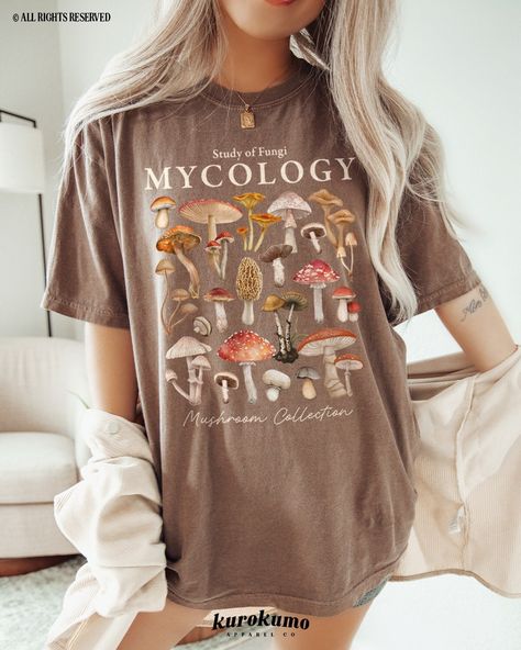 "This Unisex garment-dyed t-shirt features \"Study of Fungi | Mycology | Mushroom Collection\" with a lovely set of watercolor mushroom illustrations. It is the perfect gift for present / future mycologists, science teachers, mushroom foragers & more! Make sure to check out the other garment options below :) » O P T I O N S « ‣ Crewneck: https://www.etsy.com/listing/1700683435 » A B O U T « ‣ This item is made to order using direct-to-garment (DTG) printing technology. This digital process invol Clothes Mushroom, Mushroom Outfit, Mushroom Illustrations, Girl Camping, Watercolor Mushroom, Mushroom Cottagecore, Camping Clothes, Science Gifts, Camping Outfits