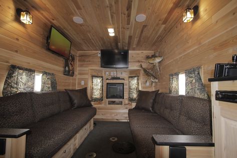 The interior of Mr. Larsen's fish house is shown. A fireplace tucked in a cozy alcove between a set of bay windows casts a glow on the tongue-and-groove cedar-paneled walls and ceiling. The couches fold out into a king-size bed. Ice Shanty Interior, Ice Castle Fish House, Ice Fishing Shack Plans, Ice Fishing Shanty, Houseboat Ideas, Ice Fishing Sled, Ice Hut, Fishing House, Ice Shanty