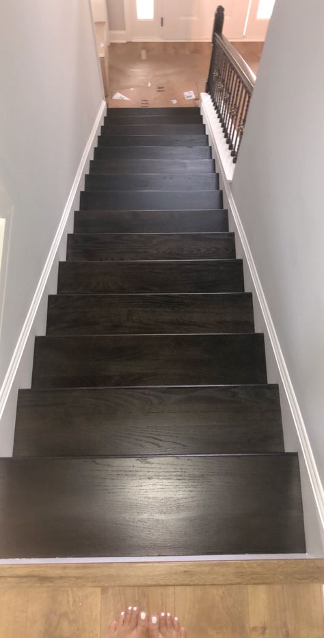 Ebony stain by Sherwin-Williams stair treads on a new build. We did 2 coats I didn’t want it too Black as I was wanting to still see the oak grain. However I probably would have had the painter done 3 coats and it would have been perfect. Still looks amazing. All Black Stairs, Black Steps, Black Stain Stairs, Black Stain Staircase, Black Stained Staircase, Black Wood Stairs, Stained Wood Stairs, Black Steps Stairways, Stained Stairs