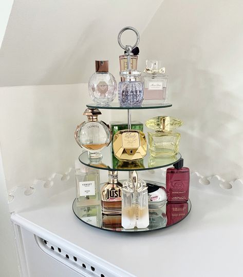 Using a 3 tier cake stand create a beautiful perfume display unit Cake Stand Perfume Display, Ways To Display Perfume, Perfume Tier Tray, Cake Stand In Bathroom, Perfume Dresser Display, Fragrance Display Stand, Bedroom Perfume Display, How To Display Perfumes, Parfume Displays