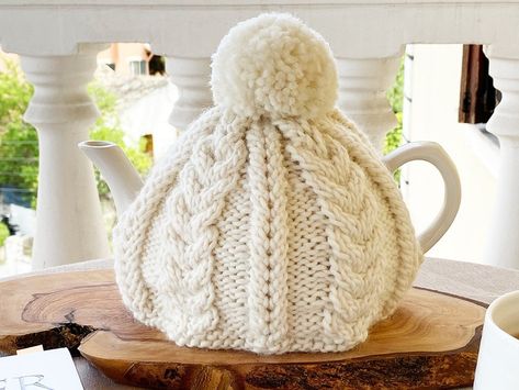 30 Free cable knitting patterns. Take a look at sweater cables and other easy cable stitch patterns to try out! Outlander Knitting Patterns, Knitted Tea Cosy, Clover Pom Pom Maker, Knit Tea Cozy, Tea Cosy Pattern, Tea Cosy Knitting Pattern, Tea Cozy Pattern, Knitted Tea Cosies, Outlander Knitting