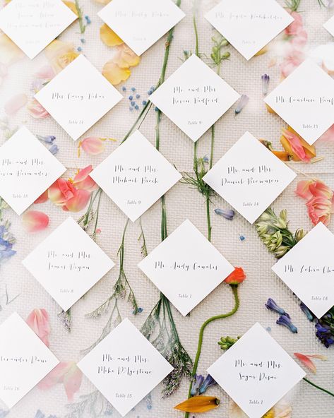 For the seating chart, wedding planner Rebecca Marín Shepherd of The Wildflowers placed pressed wildflowers between a tablecloth and a sheet of plexiglass. The table assignments were attached to the top. #weddingtableassignments #weddingseatchart #weddingreception #weddingtables | Martha Stewart Weddings - A Flower-Filled Spring Wedding in Texas Seating Chart With Favors, Floral Seating Chart Wedding, Flower Seating Chart, Diy Seating Chart, Wedding Table Planner, Secret Garden Parties, Kissing Booth, Garden Party Wedding, Martha Stewart Weddings