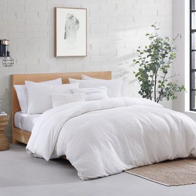 A comfortable and fashion-forward update for your bedroom can be done instantly with the DKNY Modern Waffle comforter set. Its cozy waffle texture in soft-washed cotton will envelop you in a cloud of comfort. In a crisp white color, this style will keep your bedroom dreamy. Color: White, Size: Queen | DKNY Modern Waffle 3 Piece Cotton Duvet Set Cotton in White | Queen | Wayfair | Home Decor White Waffle Bedding, Waffle Comforter, Textured Bedding, White Comforter, King Comforter Sets, Decor Pillows, Cotton Comforters, Throw Pillows Bed, Queen Comforter Sets