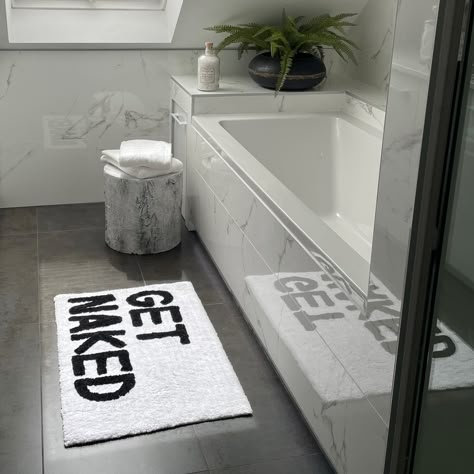 Add a touch of softness to your bathroom routine with these tufted slogan bath mats. Available in two fun choices, ‘Get Naked’ and ‘You Look Good’, these non-slip mats are sure to bring a smile to the face with every single use. Crafted using a super soft blend of cotton and polyester for comfort and long-lasting durability, these bathroom rugs are hand tufted using contrasting colours to ensure that the bold slogan stands out, producing a statement piece for your home. Black And White Bathroom Floor, Black Bathroom Floor, Black Bathrooms, Bathrooms Floors, White Bathroom Rug, Shower Floor Mat, Masculine Bathroom, Bathroom Routine