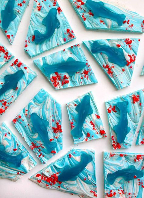 Celebrate Shark Week by making this fun and simple Shark Chocolate Bark. All you need to make it is chocolate, gummy sharks and some Pop Rocks! Shark Vs Dinosaur Party, Shark Party Desserts, Shark Rice Krispie Treats, Shark Treats For Kids, Shark Themed Birthday Party Food, Shark Week Treats, Shark Bark, Shark Treats, Shark Party Food