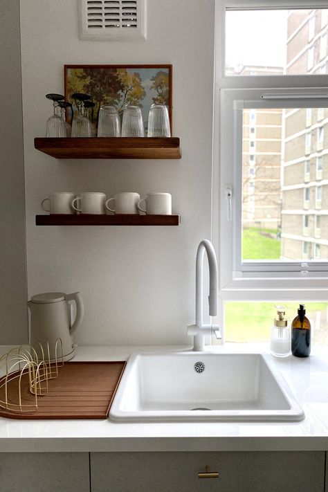 Ferren Gipson used Ikea’s Deje countertop and Haven sink in this kitchen. She sourced the matte white pull-out faucet from Tap Warehouse. Currently working from home and grateful to have their new kitchen, she and her partner Tom have been adding the finishing touches. Their Brass Dish Drainer and rainbow-shaped silicone Dish Tray are by OYOY of Denmark. “We were inspired by design elements found in commercial spaces, such as terrazzo flooring, and wanted a vaguely 1960s/70s feel,” says Ferren. Ikea Upgrades, Ikea Hack Kitchen, Kitchen Construction, White Kitchen Sink, Kitchen Guide, Interiors Kitchen, Ikea Cabinets, Terrazzo Flooring, White Sink