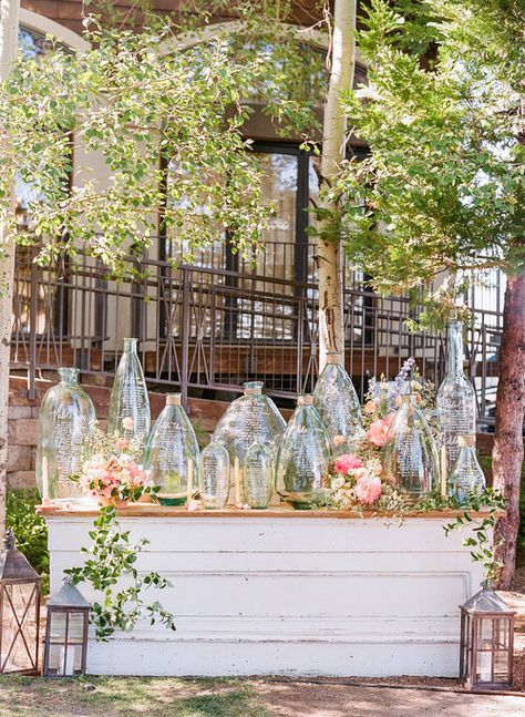 Glass Vase Seating Chart, Glass Bottle Seating Chart Wedding, Seating Chart On Table, Bottle Seating Chart, Unique Seating Chart, Wedding Table Signage, Unique Seating, Painted Glass Bottles, Martha Weddings