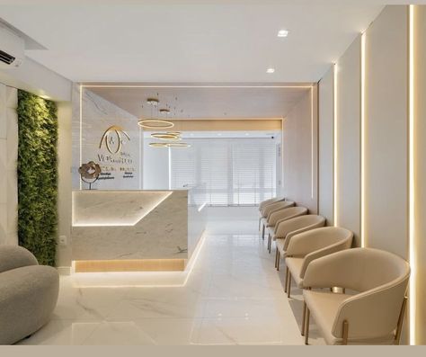 White And Gold Clinic Interior, Commercial Accent Wall Ideas, Dentist Studio Design, Esthetician Office Ideas, Dermatological Clinic Design, Modern Doctors Office Interiors, Dental Clinic Waiting Room Design, Dermatologist Office Design, Dental Office Name Ideas