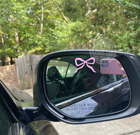 We use high quality outdoor permanent vinyl. Mirror Decal: is 1.5 inches and is not a large decal. Looking for a bow keychain?  https://www.etsy.com/listing/1650639572/pink-bow-keychain-coquette-soft-girl-era?click_key=b8009d12df7b8158d0dcbf4ad3c27f3d2927dca4%3A1650639572&click_sum=2d6057ff&ref=shop_home_active_23&pro=1&sts=1 INSTALLATION: *This is a decal which is made up of 3 parts. 1. Paper Backing - peel the design off this layer 2. Vinyl Wording - this is the actual design 3. Clear Transfer Pink Car Stickers, Stickers For Cars Ideas, Car Decal Ideas, Keychain Coquette, Girly Car Decor, Vinyl Mirror, Car Decorating, Cute Car Decals, Princess Car