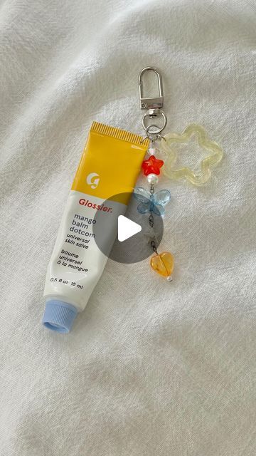 tiffany ♡ on Instagram: "I’ve been seeing these lip balm keychains pop up on social media and love any excuse to use my beads :D 
-
-
#beads #beadedkeychain #lipbalm #glossier #glossierlipbalm #balmdotcom #lipbalmkeychain #keychains" Lip Balm Charms Diy, Lip Balm Necklace, Glossier Flip Phone Keychain, Lipbalm Keychain, Lip Balm Charm Keychain, Glossier Lip Balm, Balm Dotcom, Beaded Keychains, Lip Balm