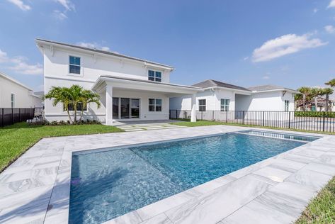 Entertaining and relaxing is a breeze from the lakefront outdoor oasis featuring an expanded covered lanai, luxurious porcelain pool pavers with turf inlays, and a generously sized pool with a sun shelf & flush spa. #floridahomes #interiordesign #realestate #homedesign #homedecor #luxuryhome #designideas #palmbeachcountyhomes #palmbeachcountyrealestate #pooldesign #poolideas #pooldecor #poolside Pavers With Turf, Pool With Sun Shelf, Sun Shelf, Covered Lanai, Pool Pavers, Pool Waterfall, Roman Tub, Flex Room, Pool Decor