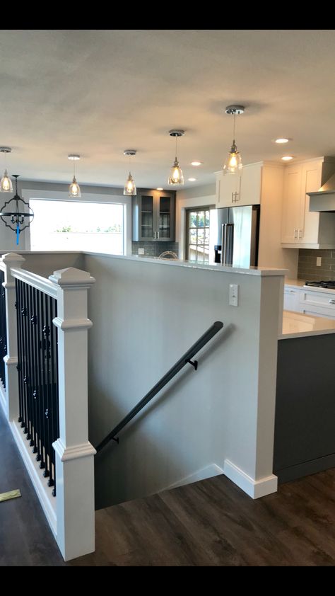 Open Concept With Basement Stairs In Middle, Opening Up Basement Staircase Wall, Open Basement Stairs In Kitchen Half Walls, Half Wall Top Of Stairs, Basement Open Staircase, Basement Stairs In Middle Of Room, Pony Wall Staircase, Stairs To Basement In Living Room, Stairs In Middle Of House