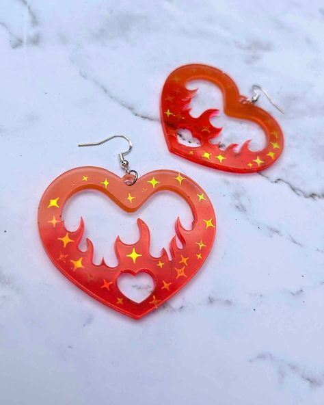 Burning Love? Make a statement with these crazy earrings.  These earrings are casted with resin, hand pigmented and poured. Glitters are placed by hand so placement could be slightly different per pair! Flame Heart, Crazy Earrings, Burning Heart, Heart Resin, Earrings Funky, Burning Love, Funky Earrings, Retro Earring, Heart Dangle Earrings