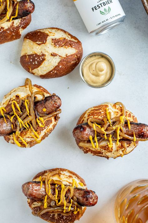 Grilled bratwurst with caramelized onions and homemade beer pretzel rolls are the ULTIMATE Oktoberfest-themed recipe. It's not every day you get to enjoy a warm pretzel roll and a snappy bratwurst in the same bite. While the homemade pretzel rolls require some extra effort and planning, it's simply not the same experience without them. #oktoberfest #bratwurstrecipes #oktoberfestrecipes Pretzel Wrapped Bratwurst, Oktoberfest Sausage Recipes, Bourbon Ham, German Food Recipes, Sausage Stuffed Shells, Pretzel Roll, Lux Kitchen, Pretzel Sandwich, Grilled Bratwurst