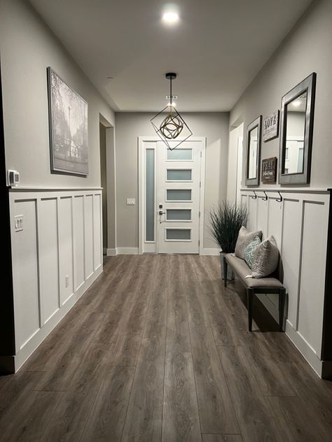 Farm house style entry way with board and batten half walls on each side DIY #farmhouselivingroom #farmhousedecor #farmhousestyle #farmhouseinspired #farmhouse #farmhouseliving #farmhouseinspo #farmhousehome #farmhousefanatics #farmhousedesign #farmhousediningroom #farmhousestyling #farmhouselife #farmhousedecorating #farmhousefurniture #farmhousekitchen #farmhousebedroom #farmhousestyledecor #farmhousechic #modernfarmhouse #foyer #boardandbatten Half Grey Wall, Farmhouse Interior Walls, Half Accent Wall Living Room, 2 Tone Wall Paint Ideas Living Room, Farmhouse Feature Wall Living Room, Farmhouse Accent Walls In Living Room, Farmhouse Wall Colors Living Rooms, Farmhouse Interior Colors, Half Board And Batten Wall