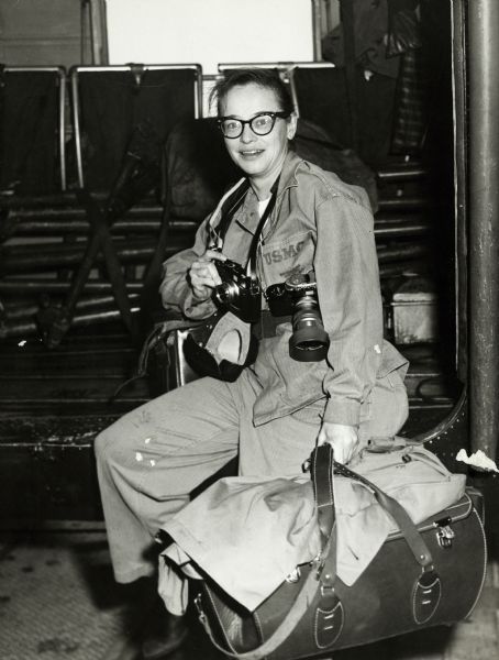 Dickey Chapelle is seated on the USS "Boxer" with cameras around her neck and luggage at her side. | Wisconsin Historical Society Sean Flynn, Women Photographers, Land Mine, Girls With Cameras, Us Marines, Famous Photographers, American Soldiers, Great Photographers, Female Photographers