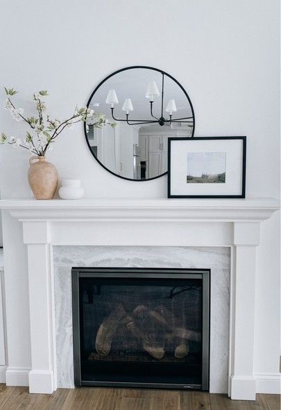 Fireplace decor for spring. McGee and Co for Target, landscape art from Etsy is super affordable. Target home, Target decor, simple hole decor, neutral home Decor. Studio McGee. Vase, black framed round mirror. Fireplace refresh, spring home decor. #LTKhome #LTKstyletip #LTKunder50 Mirror Over Fireplace Mantle Farmhouse, Mantel Decorating Ideas Circle Mirror, Round Mirror On Fireplace, Black Round Mirror Over Fireplace, Round Black Mirror Above Fireplace, Black Mirror Mantle Decor, Fireplace With Round Mirror Above, Round Black Mirror Fireplace, Vases On Fireplace Mantels