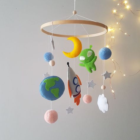 All elements are harmoniously combined in this space mobile: planet, rocket, moon and alien. It is completely neutral and will look good in a girl's or boy's nursery and will be a wonderful decoration. This unique suspension is 100% handmade, the mobile has a lot of parts and takes no more than 1-2 weeks to complete, but I will always strive to get it done as soon as possible! 🌟 Alien Baby Shower Theme, Simple Space Theme Nursery, Boy Space Nursery, Alien Nursery Theme, Alien Nursery, Nursery Planets, Baby Boy Space Theme Nursery Walmart, Space Crib Mobile, Space Nursery Theme Boys Blankets