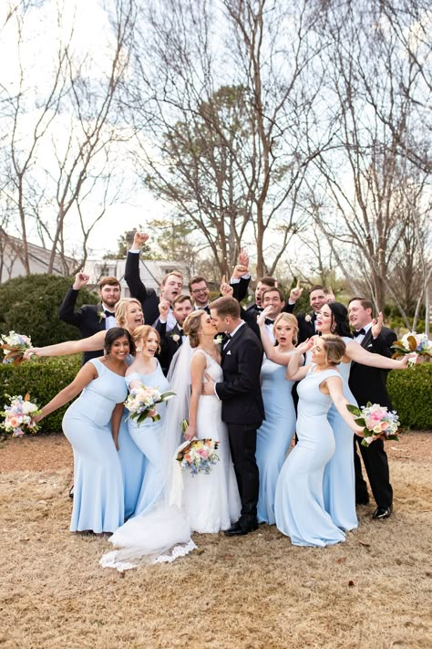 Brilliant pastel-colored bouquets looked stunning against this bridal party's beautiful blue dresses! A perfect look for the whimsical garden wedding 🌈 Light Blue Bridesmaid With Groomsmen, Bridesmaid And Groomsmen Outfits, Blue Bridesmaid Dresses Mismatched With Groomsmen, Bridesmaid Bouquet Colorful, Wedding Motif Color, Beautiful Blue Dresses, Bright Blue Wedding, Pastel Wedding Party, Elegant Spring Wedding Ideas