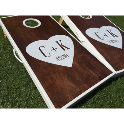 Bring the family and friends together for the best backyard fun! Whether its a wedding, BBQ, family party, or just hanging out in the back yard, cornhole is sure to be a hit. Customize: Yes | West Georgia Cornhole 10 Piece Heart Initials Custom Cornhole Board Set Plywood/Manufactured Wood in Brown, Size 48.0 H x 24.0 W x 3.5 D in | Wayfair Wedding Cornhole Boards, Bean Bag Boards, Wedding Cornhole, Cornhole Designs, Custom Cornhole Boards, Bean Bag Toss Game, Bag Toss Game, Wedding Projects, Wedding Showers