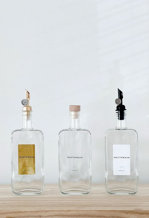 Introducing our Minimal Mouthwash Bottles, a stylish and versatile storage solution for your bathroom.  Choose between purchasing the bottles with or without labels. If you opt for labels, rest assured that we can print anything you desire on these high-quality waterproof labels, ensuring durability and longevity. These bottles are available in 2 sizes: 200 ml:  65 x 45 x 179 mm 500 ml:  88 x  45 x 220 mm  (length x width x height) Measurements do not include pourers, which are approx 5-7cm  To complete the customization process, select the lid of your choice from our range of options. Please refer to the product photos to view all available choices, including: - Black Drizzler - Clear Drizzler - Black Plastic Lid - Natural Wood Lid - Dark Wood Lid - Yellow Gold Weighted Pourer - Light Gol Glass Containers For Bathroom, Soap Dispenser Aesthetic, Shower Bottles, Bathroom Bottles, Mouthwash Dispenser, Room Vanity Ideas, Color Vibe, Waterproof Labels, Toothpaste Dispenser