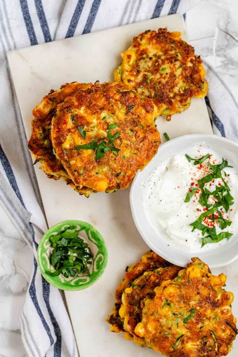 Zucchini and Corn Fritters | If you're looking for a dish that combines two summer classics - zucchini and corn, this is the perfect fit. These cheesy, crispy fritters are pan-fried and super easy to mix together. These crispy veggie fritters are great for a weekend breakfast, an appetizer or an easy weeknight dinner with a side salad. Veg Fritters, Corn And Zucchini Fritters, Zucchini And Corn Fritters, Pepper Farm, Roasted Broccoli And Carrots, Vegetarian Fritters, Zucchini Corn Fritters, Corn And Zucchini, Vegetables Dishes