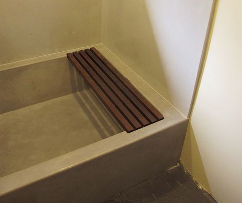 Concrete tub in a bathroom with a wood rack for setting items on. Concrete Bathtub, Concrete Shower, Concrete Bath, Walk In Shower Designs, Concrete Bathroom, Bathroom Tub, Bathroom Shower Tile, Concrete Decor, Concrete Diy