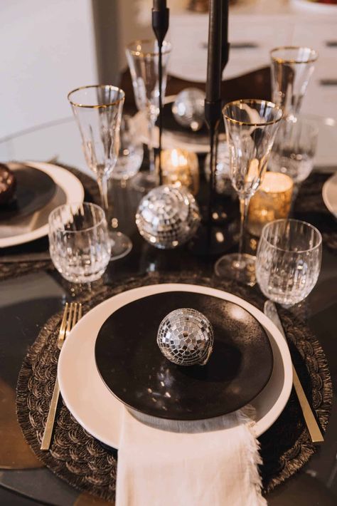 Disco balls and black and white tablescape for a NYE celebration. Entertain in style! Black And White Nye Party, Black And Gold Disco Party, Disco Ball Table Setting, Black And White Disco Party, Disco Chic Party, Disco Ball Tablescape, Black And White New Years Eve Party, Disco Table Setting, Nye Table Setting