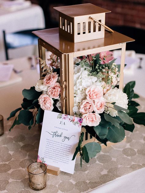 Fill gold lanterns with flowers, like this one brimming with roses for a wedding centerpiece that will light up the night. Rustic Lantern Centerpieces, Lanterns With Flowers, Lantern Centerpiece Wedding, Simple Wedding Centerpieces, Lantern Centerpieces, Bridal Shower Centerpieces, Unique Wedding Flowers, Wedding Floral Centerpieces, Wedding Lanterns