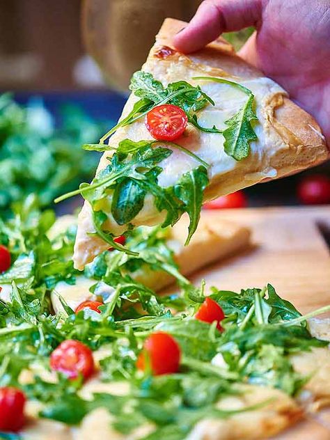 Once you’ve tasted this roasted garlic white cheese pizza with arugula salad you’ll never go back to store bought pizza again! Homemade crust is topped with a creamy, slightly spicy roasted garlic sauce, two types of cheese, and is baked to ooey gooey perfection! It’s then topped with a fresh arugula salad! Can we say perfection?! showmetheyummy.com #pizza #arugula #whitepizzasauce #whitepizza #cheese #vegetarian #garlic Pizza Arugula, Garlic White Pizza, Pizza With Arugula, Roasted Garlic Sauce, Salad Pizza, White Pizza, White Cheese, Arugula Salad, Easy Delicious Recipes