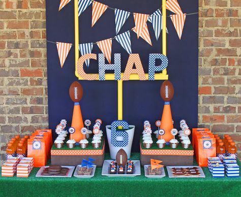 Football Party:  Astroturf from Home Depot was used as a tablecloth. A 4'x4' backboard was covered in a navy twin sheet from Walmart ($5). A field goal post was created from pvc pipe from Home Depot (details to follow). Boxes were covered in a leather-like fabric to simulate football leather and then topped with a cut piece of astroturf. Foam footballs from the Dollar Tree were put on top of megaphones (Dollar Tree), covered in cardstock and ribbon. Football Party Printables, Football Themed Birthday Party, Basketball Banquet, Senior Banquet, Football Party Decorations, Sports Baby Shower Theme, Decoration Buffet, Sports Banquet, Football Baby Shower