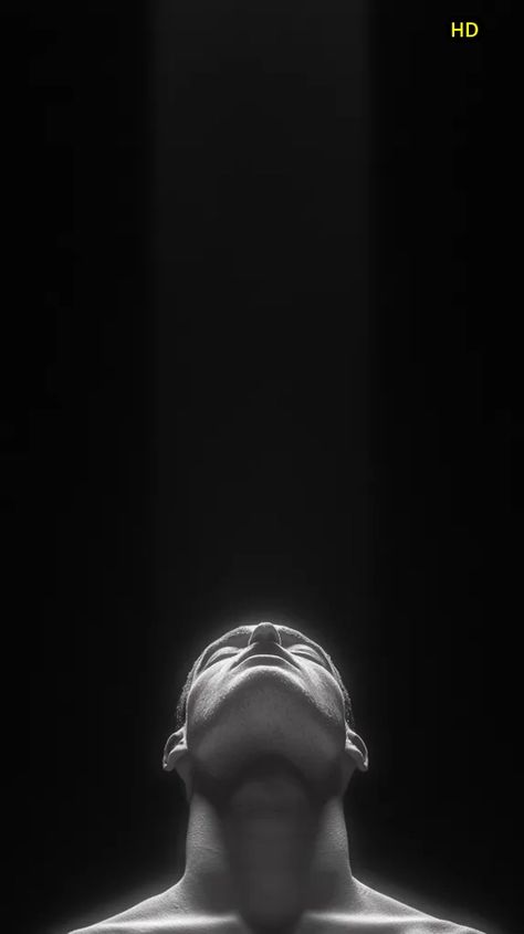 ↑↑ HD version on website. A black and white, low-key image shows a man's head and shoulders tilted upward, gazing towards a bright, unseen light source.  The stark contrast highlights the texture of his skin and the strong lines of his face and neck. The background is entirely black, drawing focus solely to the figure bathed in a narrow beam of light, creating a dramatic and contemplative mood. The image evokes feelings of serenity, introspection, or even spiritual ascension.wallpaper.webp Contrast Highlights, Black Drawing, Spiritual Ascension, Spiritual Images, Beam Of Light, Head And Shoulders, Head & Shoulders, Art Creativity, Low Key