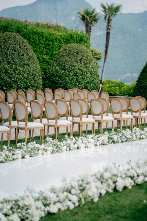 A breathtaking ceremony space with a mountain backdrop and classic white floral aisle decor. White Floral Aisle, Floral Aisle Decor, Wedding Ceremony Stage, Mountain Ceremony, Floral Aisle, Mountain Backdrop, Ceremony Decor, Aisle Decor, Wedding Ceremony Decorations