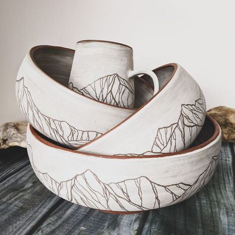 ceramics, pottery, clay, handmade, mug, bowl, bowls, serving bowl, stack, skyline, mountains, topopots Pottery Mountain Design, Ceramic Bowl Carving, Underglaze Transfer Pottery, Glaze Pottery Ideas, Pottery Mountains, Pottery Glaze Ideas, Mountain Pottery, Functional Ceramics, Beginner Pottery