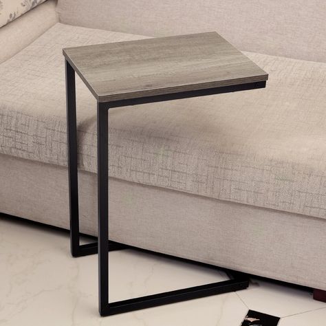 The C-shaped side table has been designed to fit at the side of your sofa or tucked under a raised sofa. These are perfect for your TV remotes, coffee, magazines or anything else you may need. The steel frame has been powder coated for a classy modern finish with a laminated wooden surface. Size: W 30 x L 40 x H 60cm Ebern Designs Spice Rack Cupboard, C Shaped Side Table, Side Table Black, Rustic Side Table, Outdoor Furniture Covers, C Table, Black Side Table, Living Room End Tables, Sofa Side Table