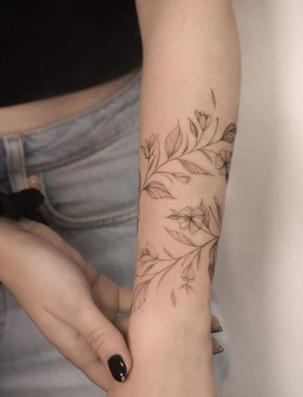 Leaf Tattoo Meaning With 50+ Tattoo Images For Inspiration Botanical Arm Band Tattoo, Upper Arm Leaf Tattoo, Leaf Bracelet Tattoo, Leaf Wrap Around Tattoo Arm, Vine Forearm Tattoo, Leaf Tattoo Meaning, Wrap Around Arm Tattoo, Oak Leaf Tattoos, Dogwood Tattoo