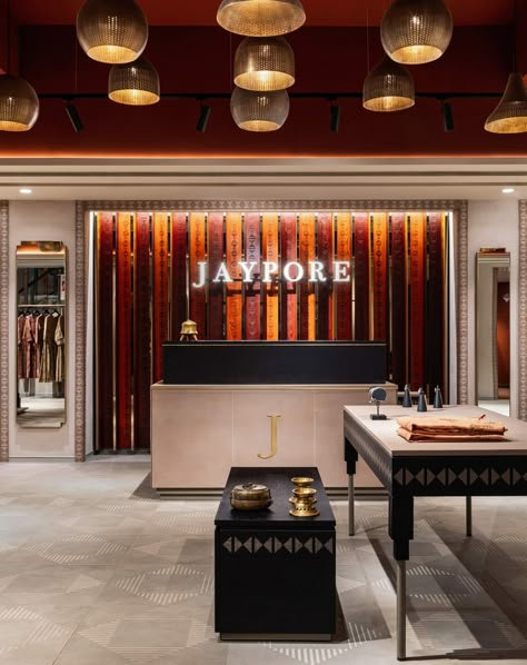 Jaypore, a mid-luxury clothing and lifestyle brand, exudes a celebration of intricate artistry found in handmade goods and exceptional craftsmanship. Textile Showroom, Saree Showroom, Luxury Clothing Store, Store Logo Design, Clothing Store Interior, Timber Slats, Store Design Boutique, Fashion Shops, Exhibition Stall