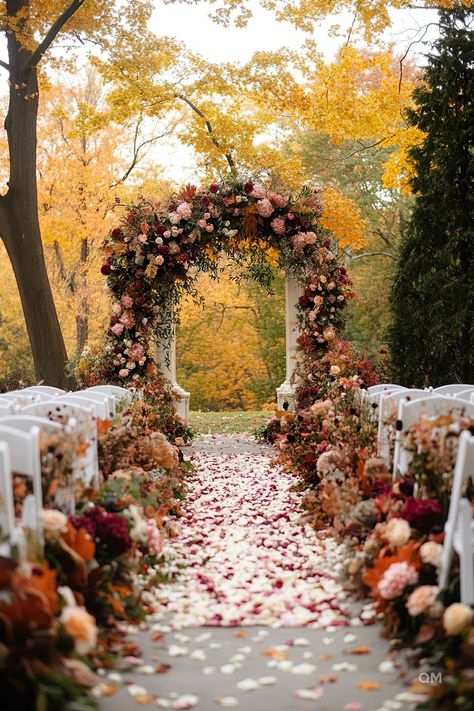 Outdoor fall wedding ceremony with a stunning floral arch in autumn colors, white chairs, and petal-strewn aisle. Perfect for October weddings. Burnt Orange Fall Wedding Decor, Fall Wedding Aisles, Autumn Outdoor Wedding Ceremony, Deep Color Wedding Theme, Fall Wedding Fairytale, Small Outdoor Fall Wedding Ideas, Fall Wedding Alter Ideas, Fall Wedding Venue Decor, Autumn Wedding Ceremony Decor