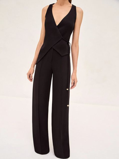 Discover the sophistication of simplicity with the Cain Vest. This elegantly tailored vest is the epitome of refined minimalism. The Cain Vest features a deep V-neckline and a wrap silhouette, secured by a side tie that accentuates the waist for a sculpted look. Perfectly paired with the Rex Pant, this combination offers a seamless transition from office elegance to evening grace. Bridesmaids In Jumpsuits, Female Officiant Attire Wedding, Officiant Outfit, Officiant Attire, Hoi An Tailor, Fancy Jumpsuit, Tailored Vest, Waist Coat, Coat Outfit