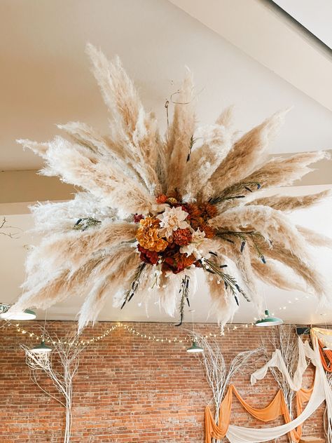 Homemade pampas grass chandelier for our wedding decor, we went with more fall colors, burgundy, burnt orange, blush and natural colors were the inspiration Pampas Grass Chandelier, Burnt Orange Weddings Decorations, Orange Wedding Decorations, Burnt Orange Weddings, Flower Chandelier, Grass Wedding, Flower Arrangements Simple, Boho Wedding Decorations, Fall Thanksgiving Decor