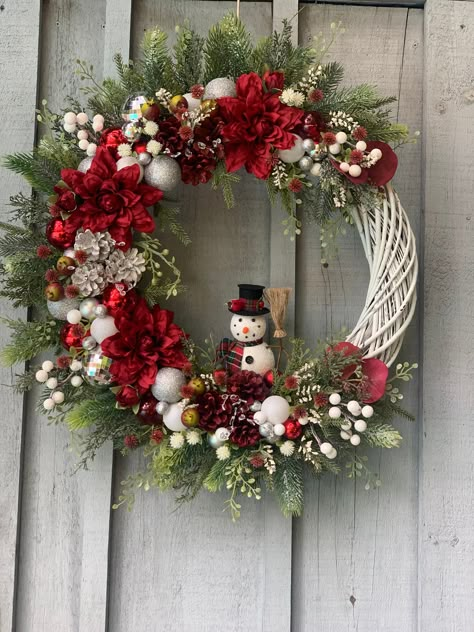 Christmas The Most Wonderful Time Of The Year! Add this elegant classic red and silver Snowman floral pinecone and Christmas ball ornament Willow wreath to your Christmas décor with its eye catching combination of shiny balls and pine cones featuring a cute Snowman and 2 large red winter dahlia's with shatterproof red, silver and white Christmas ball ornament's, silver glitter balls, red and white pinecones, red and green pomegranate berry cluster's, white sparkle berries, crystal glass sprigs, Fairy Lights On Wreath, Christmas Wreath With Balls, Christmas Wreath With Flowers, White And Red Christmas Wreath, Red White Christmas Wreath, Traditional Christmas Wreaths, Christmas Wreath Ideas Diy, Wreath Making Ideas, Winter Wreath Ideas