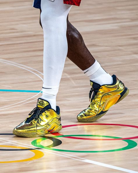 @teamusa secured gold in basketball at @paris2024 , with @kingjames donning a striking pair of gold @nike LeBron 22s for the final. The shoes, featuring shimmering gold with black detailing and signature Swoosh outlines, were a standout as millions watched the historic win. This may be LeBron’s final appearance as a USA Basketball player, and while this specific design is likely a PE, stay tuned for potential updates or releases to honor King James and Team USA’s triumph. Dripping or Trippin... Lebron James Nike, Gold Nike, Best Basketball Shoes, Usa Basketball, Nike Gold, Basketball Player, Nike Lebron, Team Usa, King James