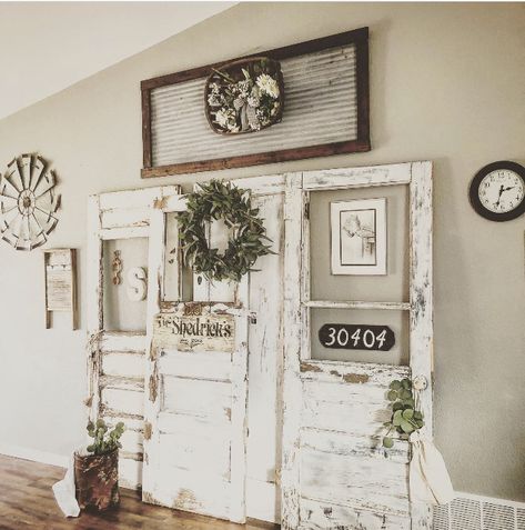 Use old doors to create a rustic farmhouse statement piece Antique Doors Decor, Old Door Hanging On Wall, Old Farmhouse Door Ideas, Old Doors As Barn Doors, Antique Door Wall Decor, Wall Of Old Doors, Old Doors Decor, Old Farmhouse Doors, Antique Door Decor Ideas