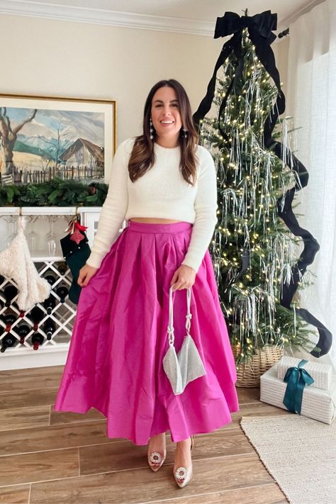 Obsessed with this look for the holidays! If you’re on the hunt for the perfect Christmas outfit, look no further than this showstopping pink skirt. Definitely a party staple. This special stunning skirt will turn heads wherever you go. Rock it with a cozy white sweater, some adorable shoes, and a sparkling purse for an aesthetic holiday look. Follow me for more outfit ideas for women. Holland Paterno. Christmas Outfit Pink Skirt Outfit Winter, Pink Skirt Outfit Ideas, Pink Pleated Skirt Outfit, Pink Christmas Outfit, Pleated Skirt Outfit Ideas, Pink Skirt Outfit, Cozy White Sweater, Pink Skirt Outfits, Festive Christmas Outfit