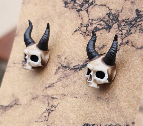 Lightweight & unique aged bone colour horned skull stud earrings.  These earrings are a unique design modelled in a 3D CAD programme and printed using a resin 3D printer, handfinshed & handpainted using cream & brown acrylic paint to create an aged bone effect, & coated with a layer of varnish for protection.  Made from stainless steel ear posts and ear nuts, and a resin horned skull, & fixed together using ultra strong epoxy resin glue.  The small skull studs measure approximately 6mm X 10mm. T Skull Decor Diy, Skull Shape, Resin Glue, Brown Acrylic, Stud Earrings Unique, Small Skull, Gothic Earrings, Bone Color, Polymer Clay Dolls