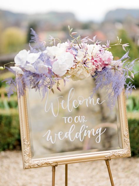 Wedding decoration with pastel flowers to welcome Lavender Style Wedding, Lavender Wedding Theme Ceremony Decor, Floral Arch Wedding Purple, Pastel Pink And Lilac Wedding, Purple Wedding Welcome Sign, Pastel Themed Wedding Reception, Lavender Aisle Decor, Lilac And Beige Wedding, Wedding Themes Lilac