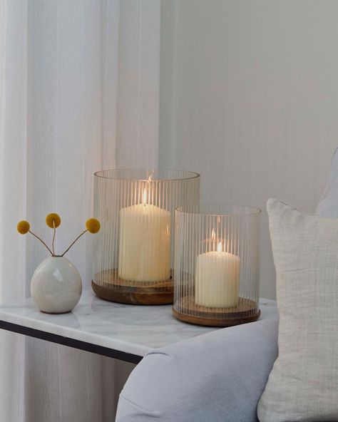 The simple yet refined Amelia Candle Holder taps into the minimalist trend, whilst still offering a statement piece to your winter styling. Made from sustainably sourced wood, the ribbed glass creates enchanting shadows as the candlelight flickers. #livingroom #livingroominspiration #cosy #countryliving #countryhomestyle #livingroomrug #livingroomfurniture #sofastyling #layers #neutrallivingroom #neutralliving #homecomforts #mywhiteco #moderncountry #interior #cosysaturday #restylinghome #... Ribbed Glasses, Sulking Room Pink, Windowsill Decor, Season Change, Wooden Candle Holder, Cosy Spaces, Winter Styling, Large Candle Holders, Wooden Candle