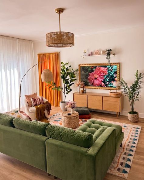 Picture of a cozy living room with a green sectiona, a rug, a curved sofa, a side table, a TV unit, a woven chandelier and potted plants Cheap Couches, Green Sofas, Monochromatic Living Room, Striped Furniture, Green Sofa Living Room, Maximalist Living Room, Light Green Walls, Bold Living Room, Earthy Living Room