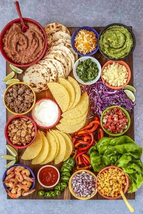 Up your night game with a beautiful build-your-own board made with Mexican inspiration. This roundup has it all, from tacos and burrito bowls to even a make-your-own margarita station. You'll be the talk of any holiday party or family gathering with these festive and delicious dishes! #ChristmasCharcuterieBoard #Christmas #Charcuterie Taco Board, Decorações Com Comidas, Charcuterie Inspiration, Charcuterie Platter, Party Food Platters, Charcuterie And Cheese Board, Charcuterie Recipes, Party Food Appetizers, Food Platters